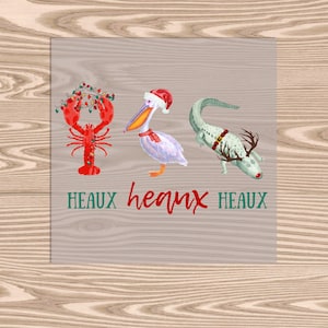 May include: A whimsical illustration features a red lobster adorned with Christmas lights, a pelican in a Santa hat, and an alligator with antlers. The text "HEAUX heaux HEAUX" is written below in green and red. The image has a light brown wood grain background.