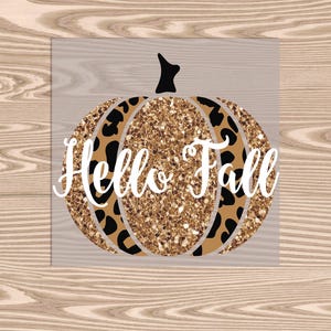 May include: A gold glitter pumpkin with a black and brown leopard print design. The text "Hello Fall" is written in white on the pumpkin.