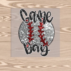 May include: A glittery silver baseball with red stitching and the text "Game Day" in black glitter.