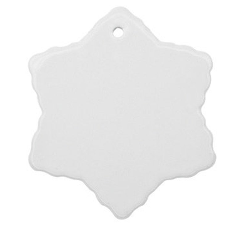 May include: White ceramic snowflake ornament with a hole for hanging.