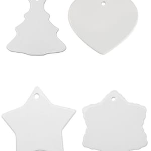 May include: Four blank white ceramic ornaments in different shapes: a Christmas tree, a heart, a star, and a snowflake. Each ornament has a hole for hanging.