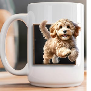 May include: A white ceramic mug featuring a graphic print of a fluffy, light brown puppy with curly fur. The puppy is depicted as if jumping out of a square, dark-colored frame, showing its face, front paws, and tail in a dynamic pose.