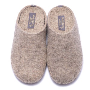 May include: A pair of gray wool slippers with a brown leather trim. The slippers have a label on the top that says "Made for You 100% Wool Size 7 www.madeforyou.com".