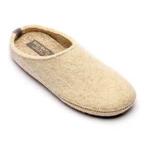 100% wool slippers with rubber soles in various widths and fits. Home shoes are comfortable due to arch support and natural fibers. Women's slippers are light beige color in natural fibers that prevent feet from sweat and odors