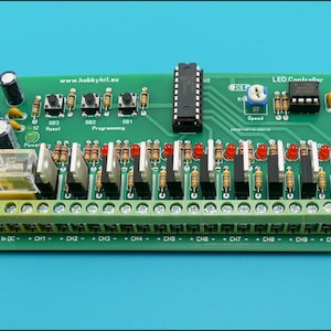 May include: A green circuit board with an LED controller, 10 channels, and a speed control knob. The board has a fuse, reset button, and programming buttons. The text "www.hobbykit.eu" is printed on the board.