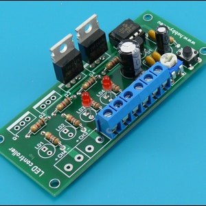 May include: A green circuit board with the text "LED controller" printed on it. The board has four red LEDs, four resistors, two transistors, a potentiometer, a push button, two capacitors, and a terminal block. The text "www.hobby...eu" is printed on the board.