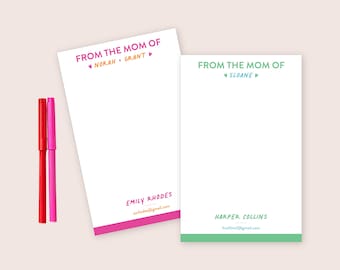 May include: Two rectangular white notepads with coloured borders and text. One features pink text reading FROM THE MOM OF NORAH GRANT and EMILY RHODES with an email address. The other has green text reading FROM THE MOM OF SLOANE and HARPER COLLINS.