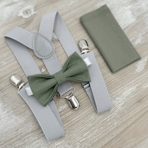 May include: A set of gray suspenders, a green bow tie, and a green pocket square. The suspenders have silver clips. The bow tie is made of a soft fabric. The pocket square is a solid color.