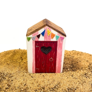 Little wooden beach hut. Miniature seaside beach house. Nautical driftwood style decoration