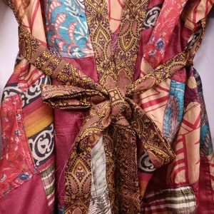 "Luxurious silk kimono adorned with a patchwork of brilliant hues"