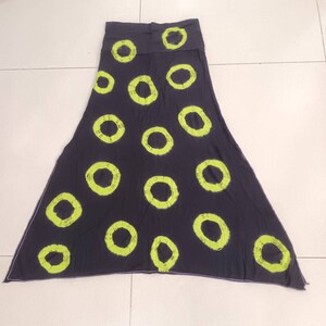 May include: A dark gray maxi skirt with a lime green circle pattern.
