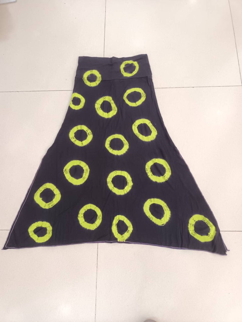 May include: A dark gray maxi skirt with a lime green circle pattern.