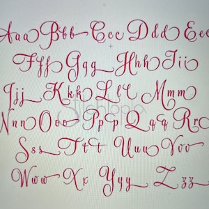 May include: A red, handwritten alphabet in both uppercase and lowercase letters. The letters are displayed in a cursive font style, with each letter carefully crafted. The letters are arranged in rows and columns, showcasing the full alphabet.