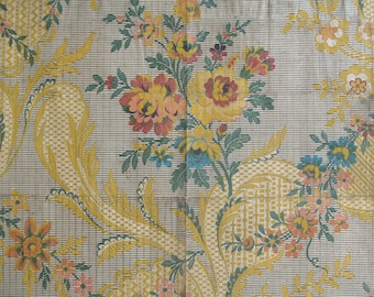 May include: A vintage floral fabric with a repeating pattern of yellow, pink, and blue flowers on a white background. The fabric has a woven texture and a subtle grid pattern.