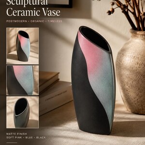 May include: A sculptural ceramic vase with a matte finish, featuring a curved, asymmetrical design. The surface displays a color-blocked pattern of soft pink, muted blue, and solid black, with a slanted top opening and a deep black interior.