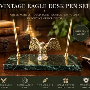 May include: A desk pen set featuring a rectangular green marble base with a gold-tone eagle figurine in the center. Two gold-tone pens are held in upright holders on either side of the eagle. Text on the image reads VINTAGE EAGLE DESK PEN SET, GREEN MARBLE, GOLD TONE, DOUBLE PEN HOLDER, EXECUTIVE OFFICE DECOR, BOTH PENS WRITE, CLASSIC EAGLE DESIGN, TWO WORKING PENS, GREAT GIFT FOR ANY OCCASION, PATRIOTIC & TIMELESS.