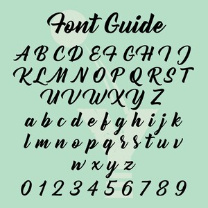 May include: Font guide with uppercase and lowercase letters and numbers in a black cursive font on a light green background.