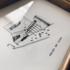 May include: A black and white line drawing of the Walker Art Center building in Minneapolis, Minnesota. The drawing is in a simple style and shows the building's unique architecture.