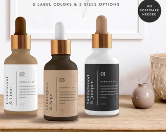 May include: Three glass bottles with dropper tops and labels. The bottles are filled with a clear liquid. The labels are brown, black, and white with text that reads "Cedarwood & Lime", "Lemongrass & Sage", and "Sandalwood & Juniper". The bottles are arranged in a row on a wooden surface.