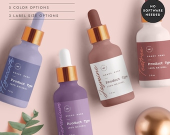 May include: Four glass bottles with dropper tops and labels. The bottles are filled with liquid and have labels with the names "Hyacinth", "Geranium", "Jasmine", and "Teatree". Each label also includes the text "Brand Name", "Product Type", and "100% Natural". The bottles are arranged on a pink background with a gold sphere and green leaves.