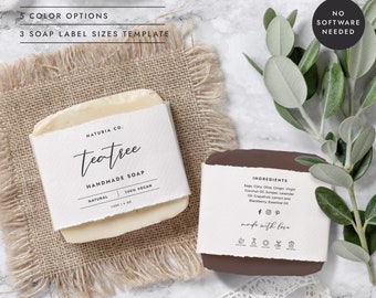 May include: Two handmade soap bars with labels. The first bar is white with a label that reads "Natura Co. teatree HANDMADE SOAP NATURAL 100% VEGAN 120G 1.4 OZ". The second bar is brown with a label that reads "INGREDIENTS Sage Clary Olive Ginger Virgin Coconut Oil Juniper Lavender Oil Grapefruit Lemon and Blackberry Essential Oil fp made with love".