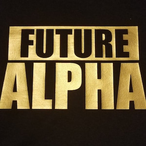 May include: Black t-shirt with gold foil lettering that reads "FUTURE ALPHA".