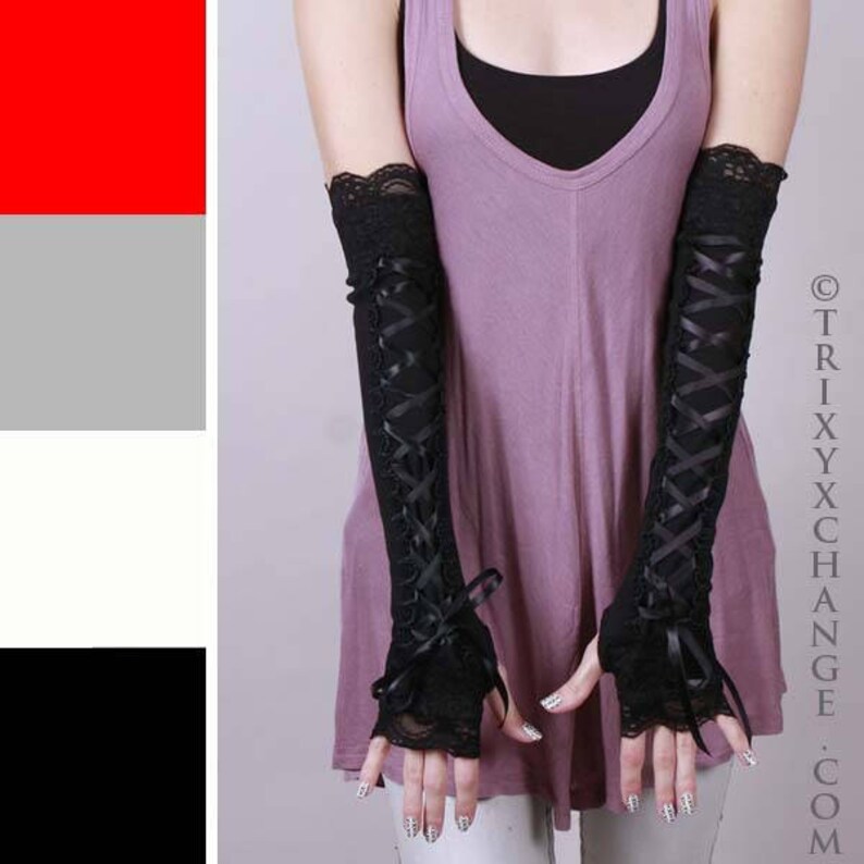 May include: A pair of black lace fingerless gloves with ribbon lacing. The gloves are worn by a person wearing a purple top.