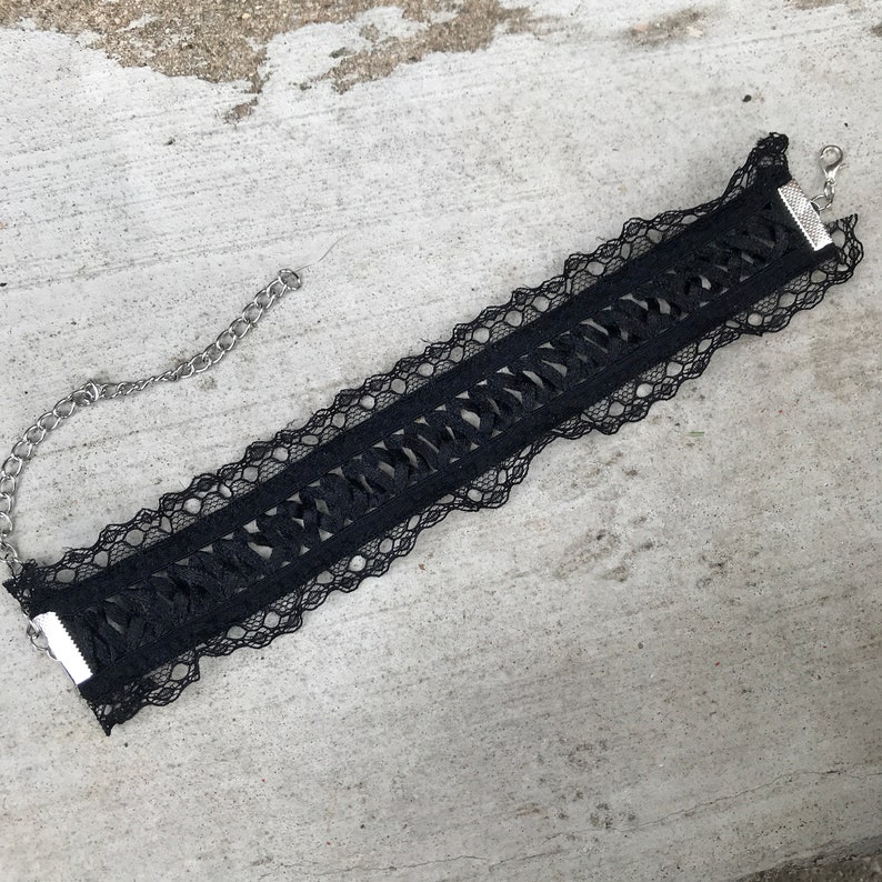 May include: Black lace choker necklace with a silver chain and clasp.