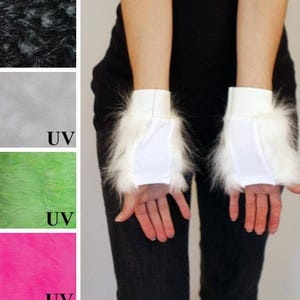 May include: A pair of white fingerless gloves featuring long faux fur trim around the wrist and a smooth fabric palm section. The image includes color swatches of black, white, neon green, and hot pink faux fur, with UV labels on select swatches.