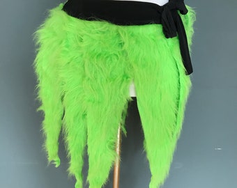 May include: A lime green fluffy skirt with a black waistband and a black bow tie. The skirt is made of faux fur and has a frayed edge.