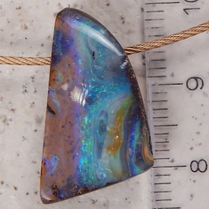 May include: A triangular opal pendant with a blue, green, and brown iridescent pattern. The pendant is hanging from a silver chain.