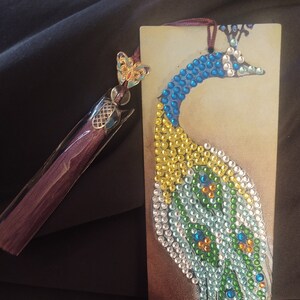 Completed diamond painting bookmark of a peacock