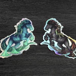 May include: Two iridescent stickers featuring a black and a blue horse with green foliage growing from their bodies. The horses are depicted in a rearing pose.