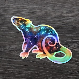 May include: A holographic sticker of a rat with a galaxy design. The rat is depicted in a side profile, with a swirling tail and a starry pattern in shades of blue, purple, and orange. The sticker has a glossy finish.