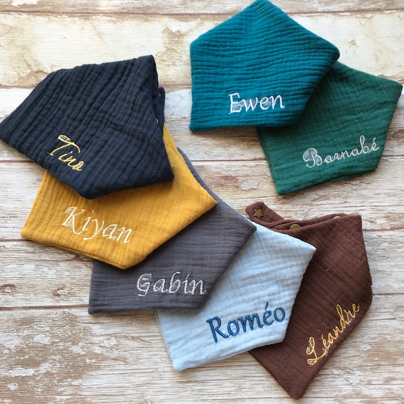 May include: Seven different colored fabric baby bibs with embroidered names:  Tino, Kiyan, Gabin, Romeo, Barnab&eacute;, Ewen, and Leandie.