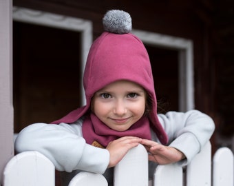 SET. Children's dark pink  winter cap with a pompom and scarf.