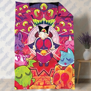 May include: A rectangular throw blanket featuring a vibrant, multi-colored graphic print of a central dark character reading a book, surrounded by various stylized creatures and a large, many-eyed monster head in shades of pink, red, and yellow.