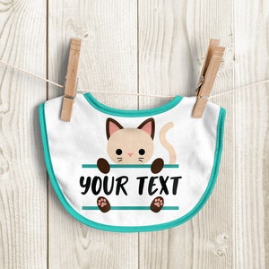 May include: A white baby bib with a turquoise trim. A cartoon cat with brown paws is peeking over a turquoise bar with the text "YOUR TEXT" printed on it.