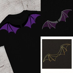 May include: Three pairs of wings in different styles. The first pair is purple and black, the second pair is purple and white, and the third pair is gold. The wings are on a black background.