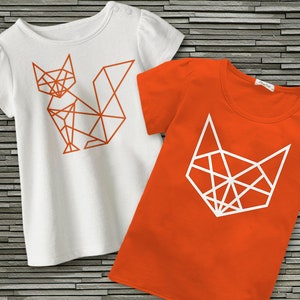May include: Two t-shirts featuring geometric fox designs. One shirt is white with an orange fox, the other is orange with a white fox.