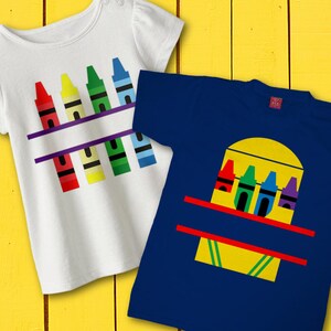 May include: Two t-shirts with a crayon design. The white t-shirt has a row of crayons across the chest. The blue t-shirt has a box of crayons with a yellow background.