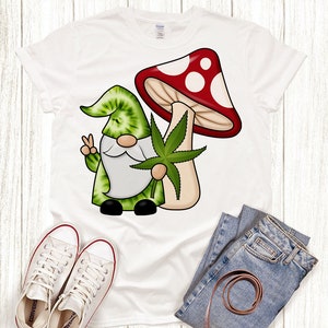 May include: White t-shirt with a green and red cartoon gnome holding a green marijuana leaf and a red and white mushroom.