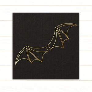 May include: A pair of gold wings on a black background. The wings are stylized and have a pointed shape.