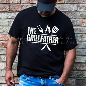 May include: A black t-shirt with white text that reads "The Grillfather" with a grill utensil graphic.