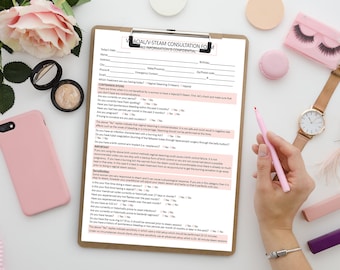 May include: A white consultation form with the title "Vaginal V-Steam Consultation Form" and the text "All Information is Confidential". The form includes questions about medical history, menstrual cycle, and other relevant information. The form is on a clipboard with a pink pen and other pink accessories on a white surface.