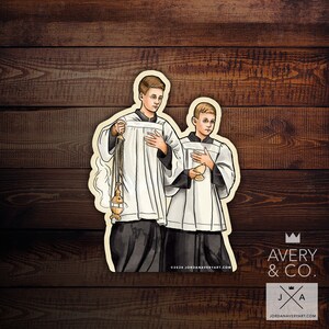 May include: A sticker featuring two figures in white robes and black cassocks, holding religious items. One figure holds a censer, the other a chalice. The sticker has a cream-colored border and the text "©2024 JORDANAVERYART.COM".