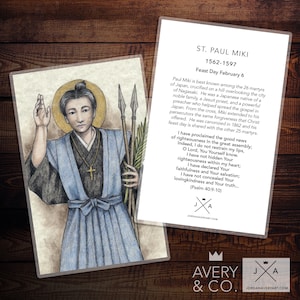 May include: A vintage-style illustration of Saint Paul Miki, a Japanese Jesuit priest and martyr. The image is in shades of blue and grey, with a simple background. The text below the image reads "ST. PAUL MIKI 1562-1597 Feast Day February 6".