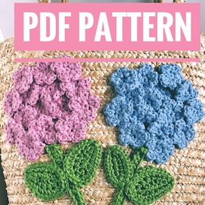 May include: A crochet flower pattern for a straw bag. The pattern includes two flowers, one pink and one blue, with green leaves and stems.
