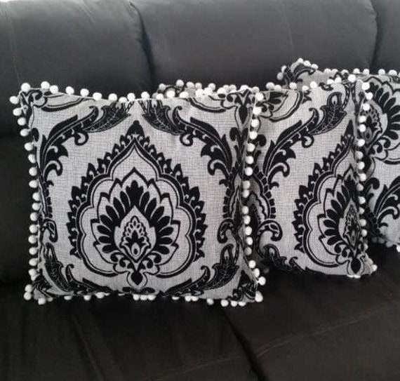 white pillows with black trim