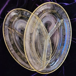 May include: Two clear glass divided serving dishes with a gold rim and etched floral design.